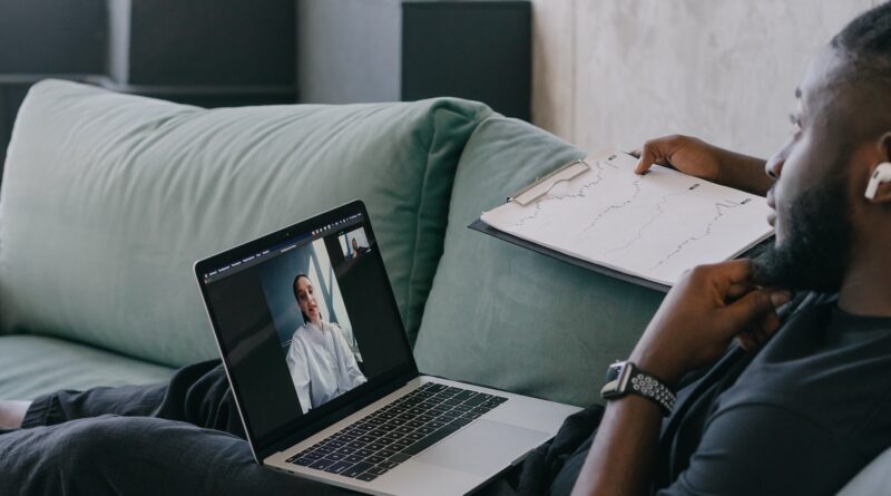 Person in Black Long Sleeve Shirt Using Macbook Pro