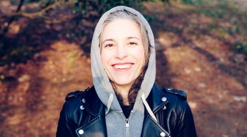 woman smiling near tree