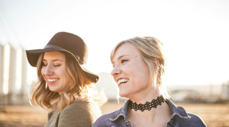 two woman taking a sideview selfie